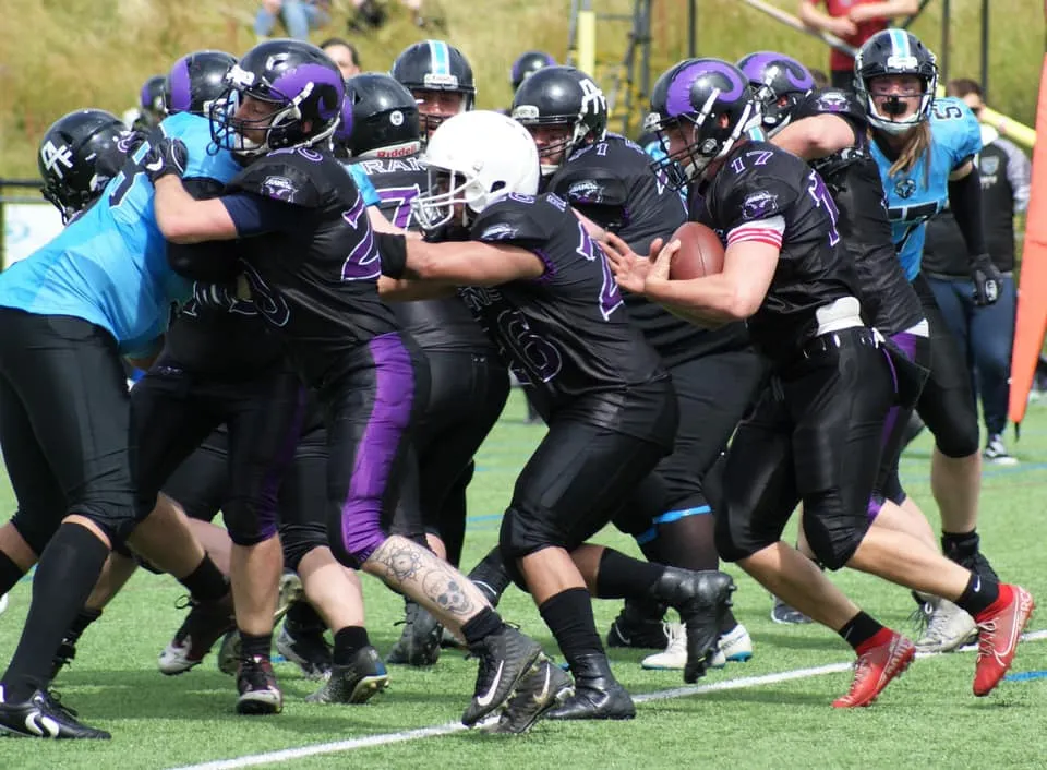 Quarterback Joe Mills runs behind his offensive line