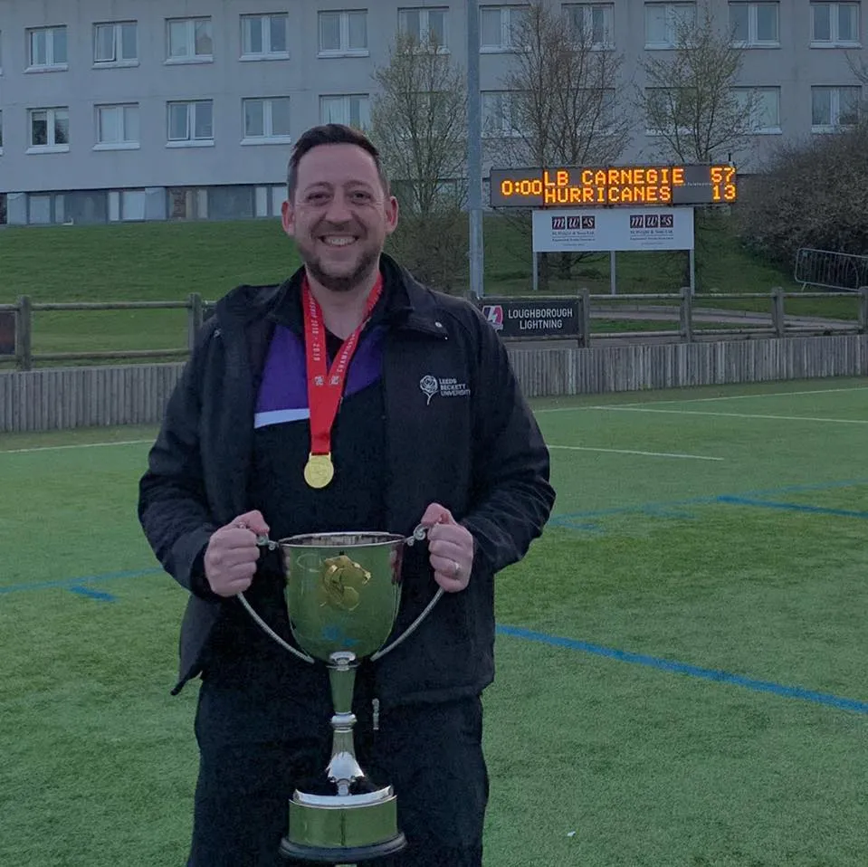 Coach Shaw holds the BUCS National Championship trophy after winning it with Carnegie American Football