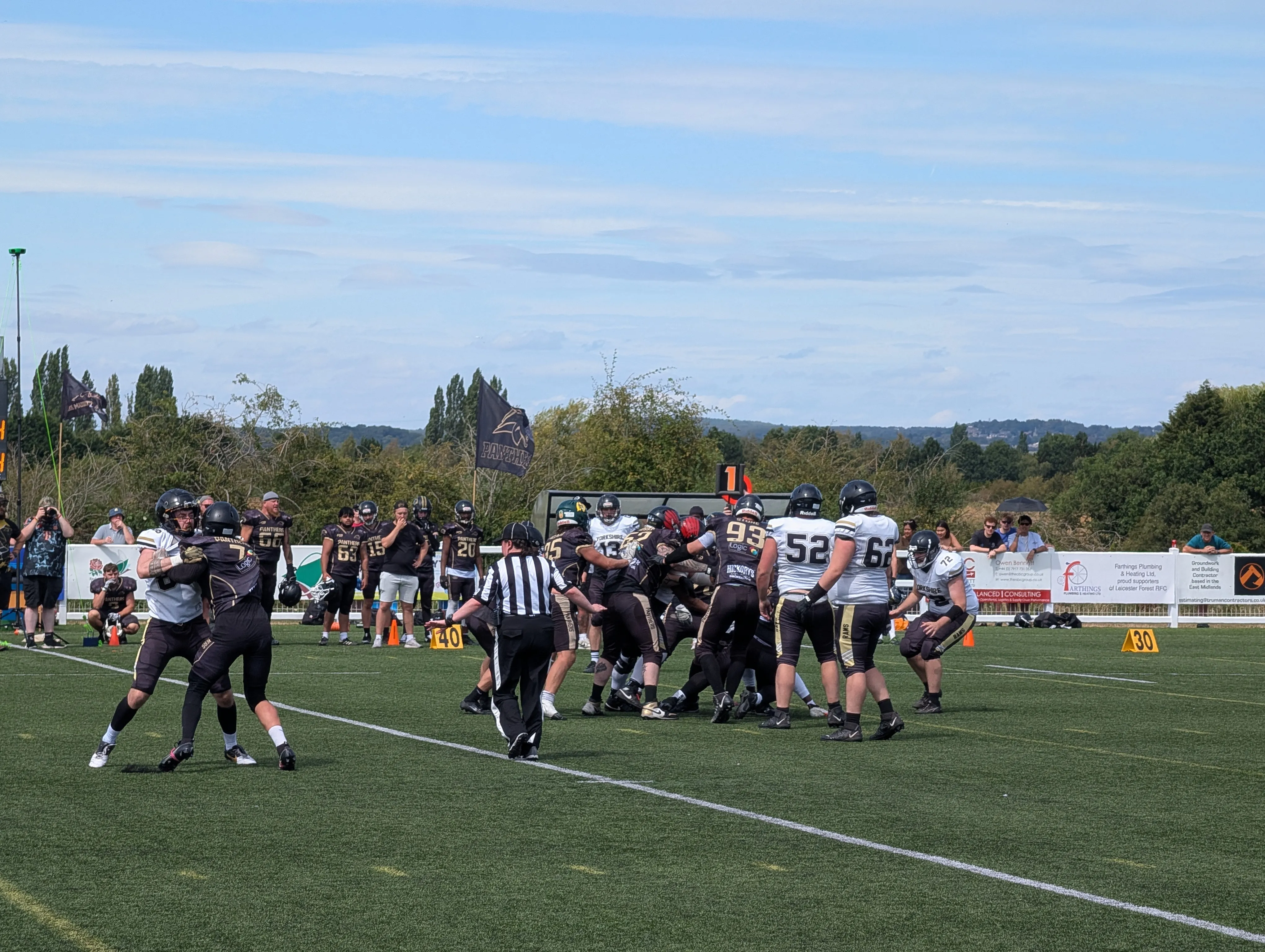 The Rams defence swarms to the ball against the Panthers