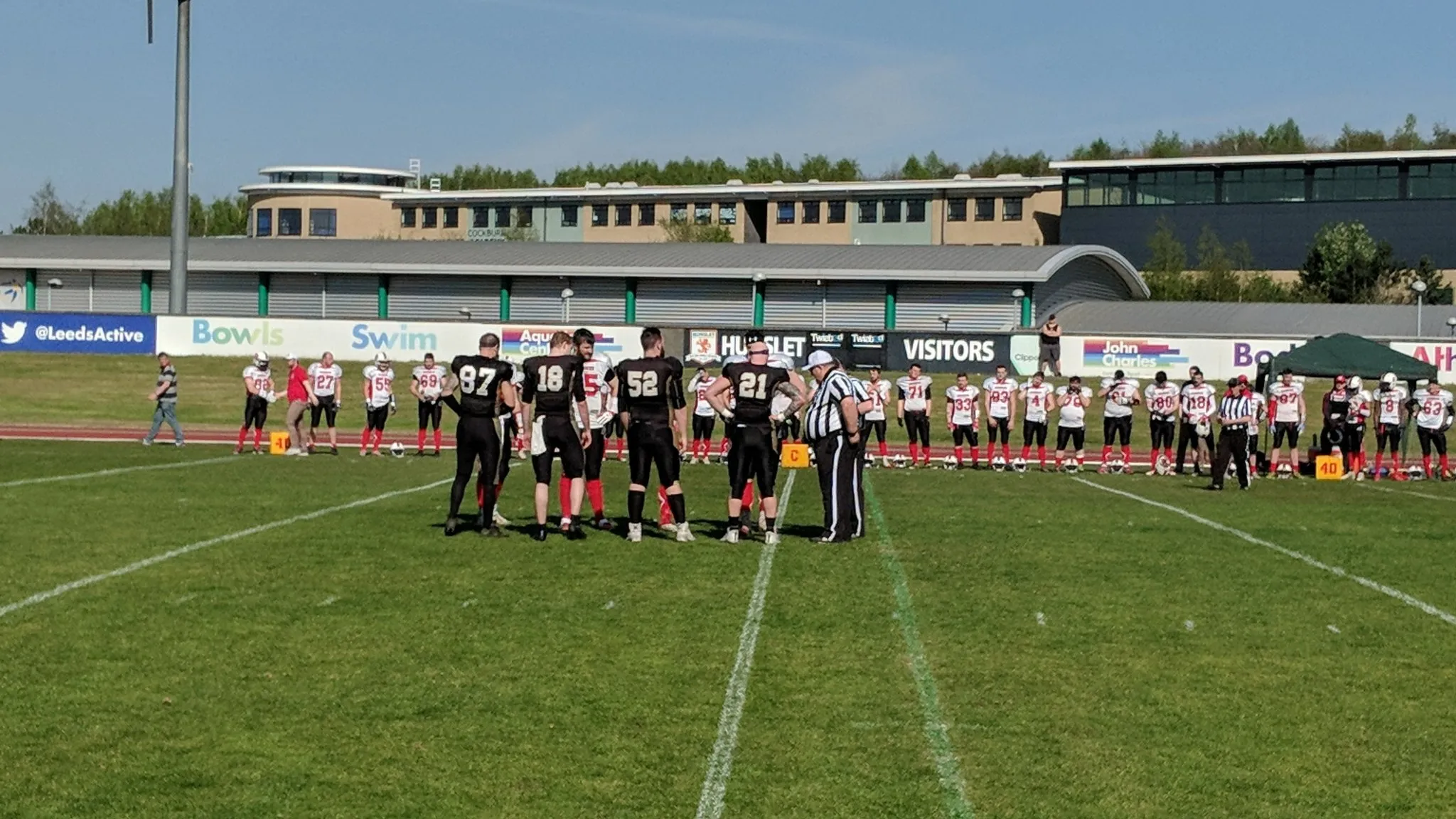 The captains meet in the middle of the field